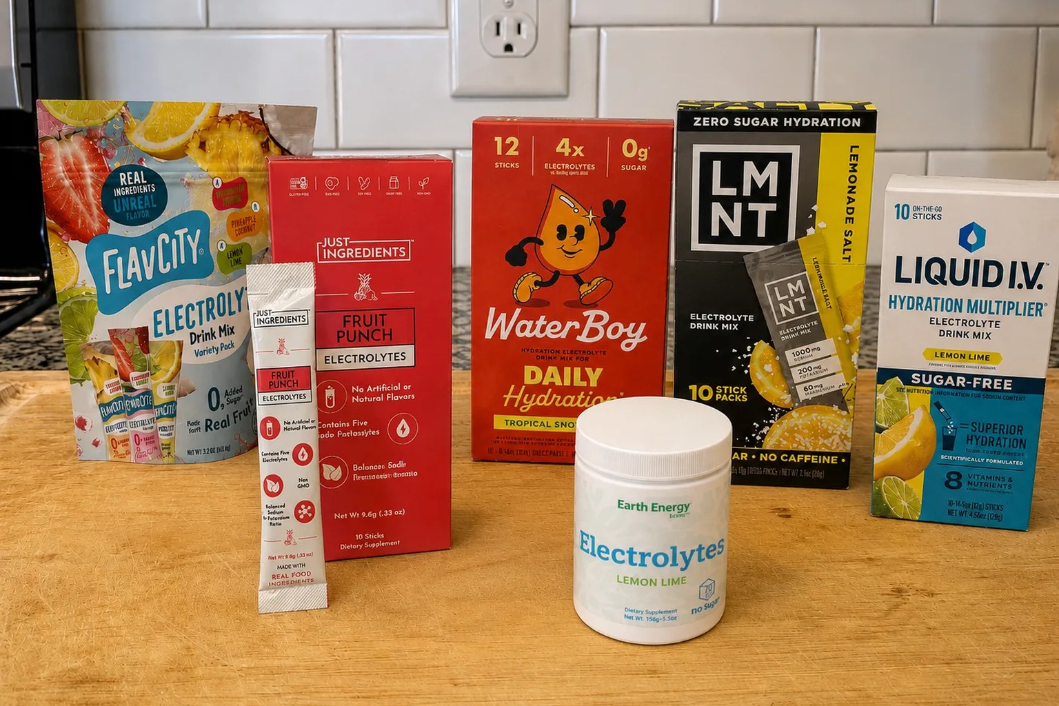 The seven electrolyte products we compared on our counter: FlavCity, Just Ingredients, Waterboy, LMNT, Liquid I.V. and Earth Energy