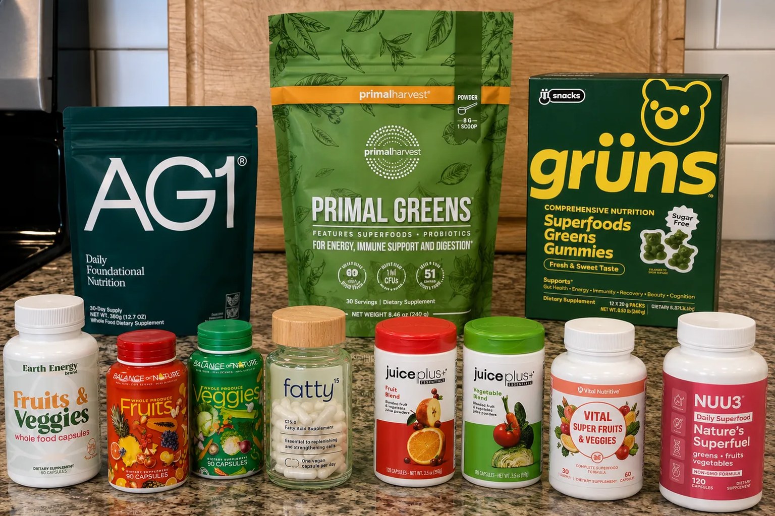 The fruit, vegetable and greens supplements we compared on our counter: AG1, Primal Greens, Grüns, Earth Energy, Balance of Nature, Juice Plus+, Vital and NUU3