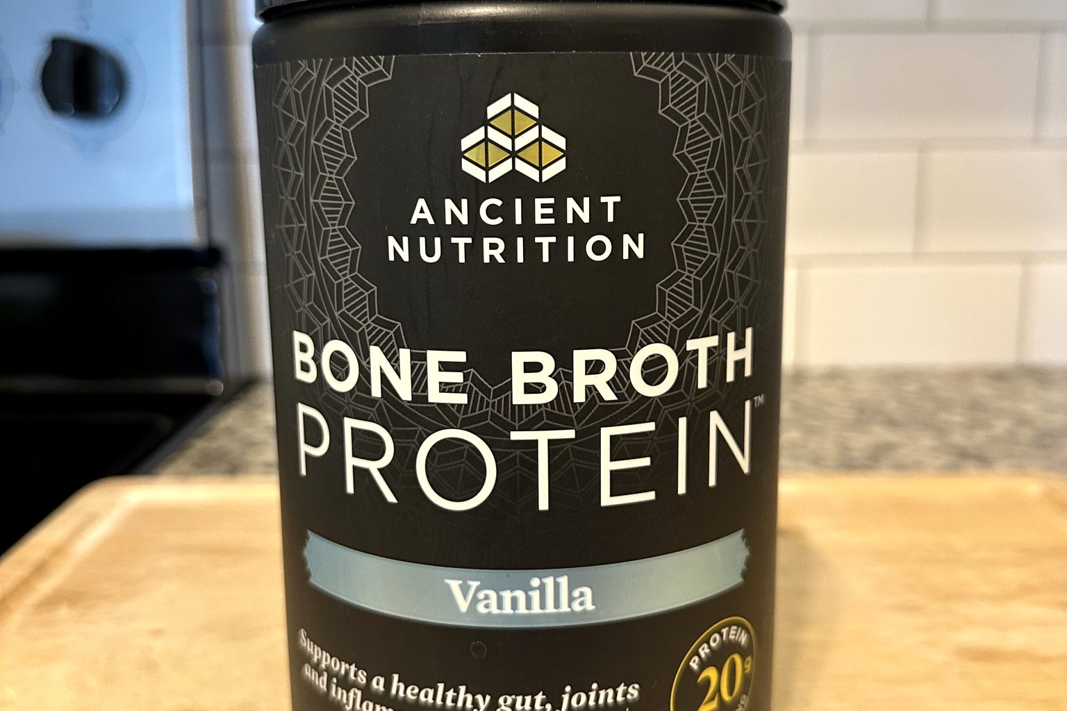 Ancient Nutrition Bone Broth Protein Vanilla tub on our kitchen counter, 20g protein per serving