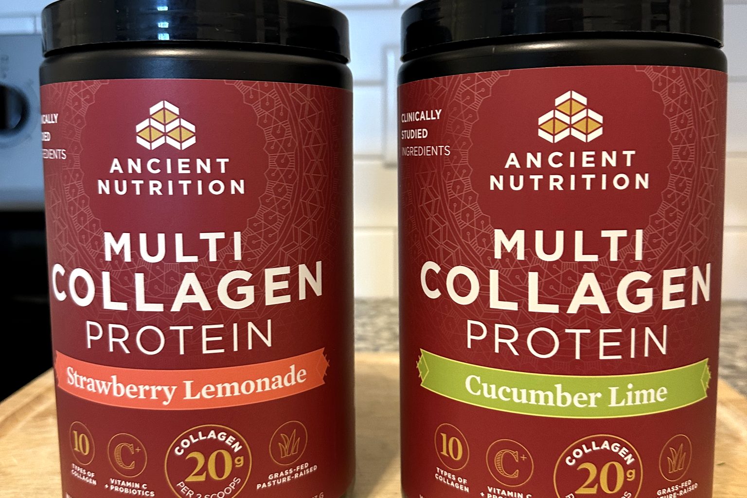 Ancient Nutrition Multi Collagen Protein jars (Strawberry Lemonade and Cucumber Lime) on our kitchen counter, 20g collagen per two scoops