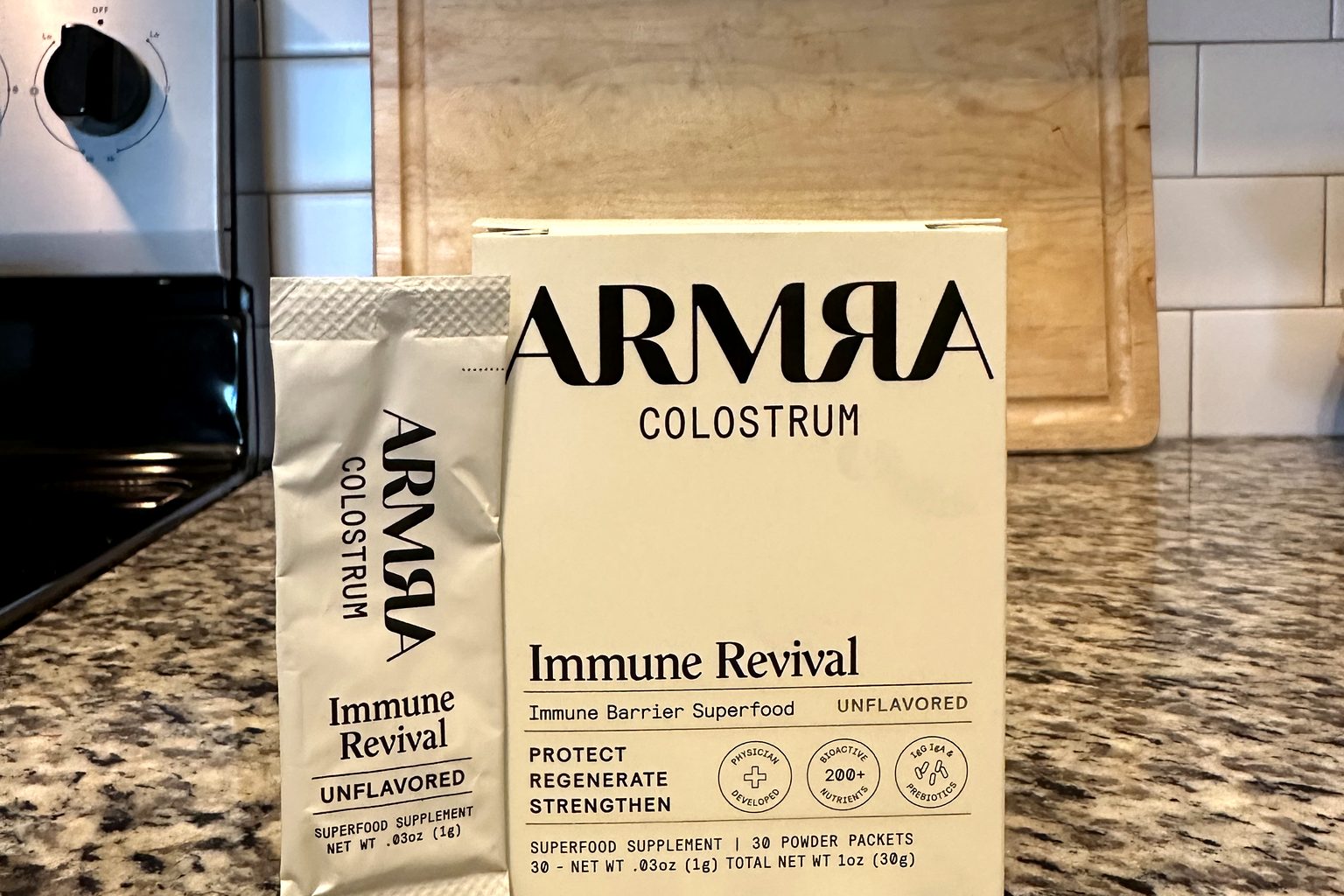 The ARMRA Colostrum Immune Revival box and packet we purchased, photographed on a kitchen counter