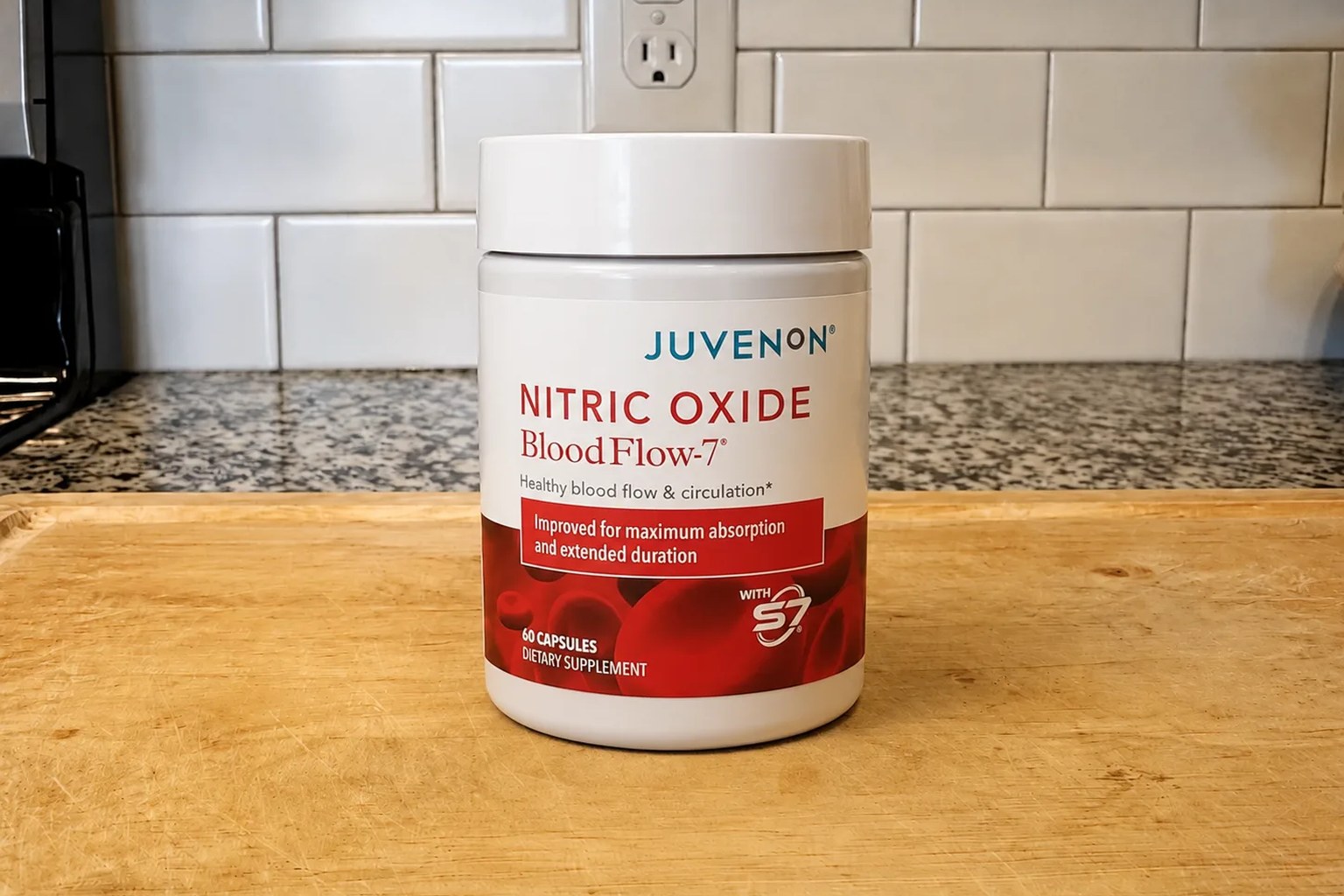 A BloodFlow-7 bottle by Juvenon on our kitchen counter, 60-capsule, 30-serving supply