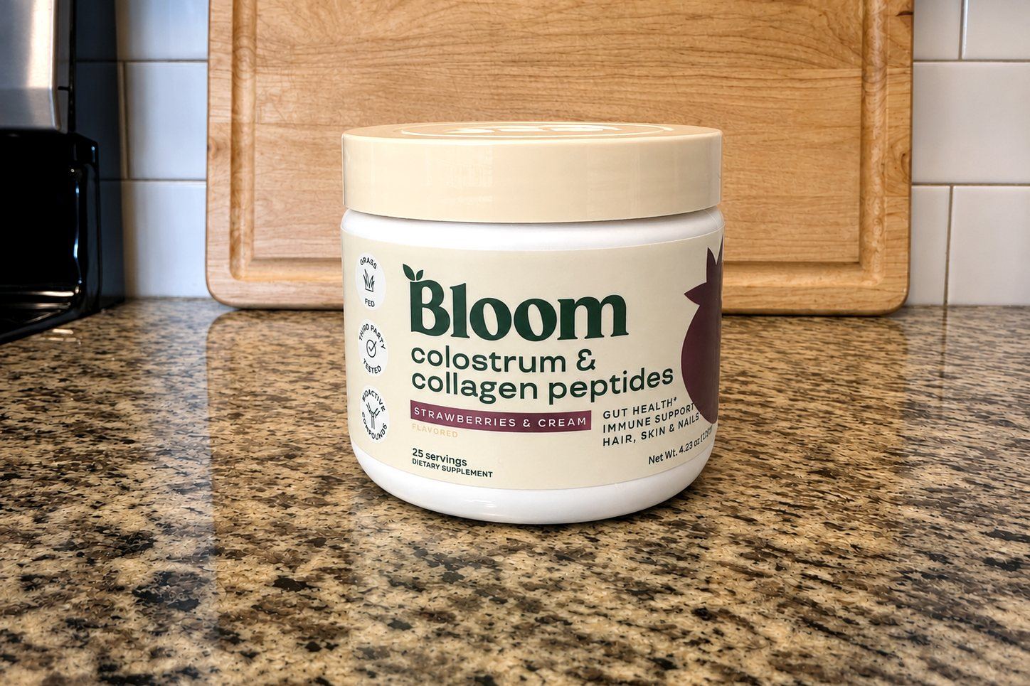 Bloom Nutrition Colostrum and Collagen Peptides jar, Strawberries and Cream flavor, 25 servings, on our kitchen counter