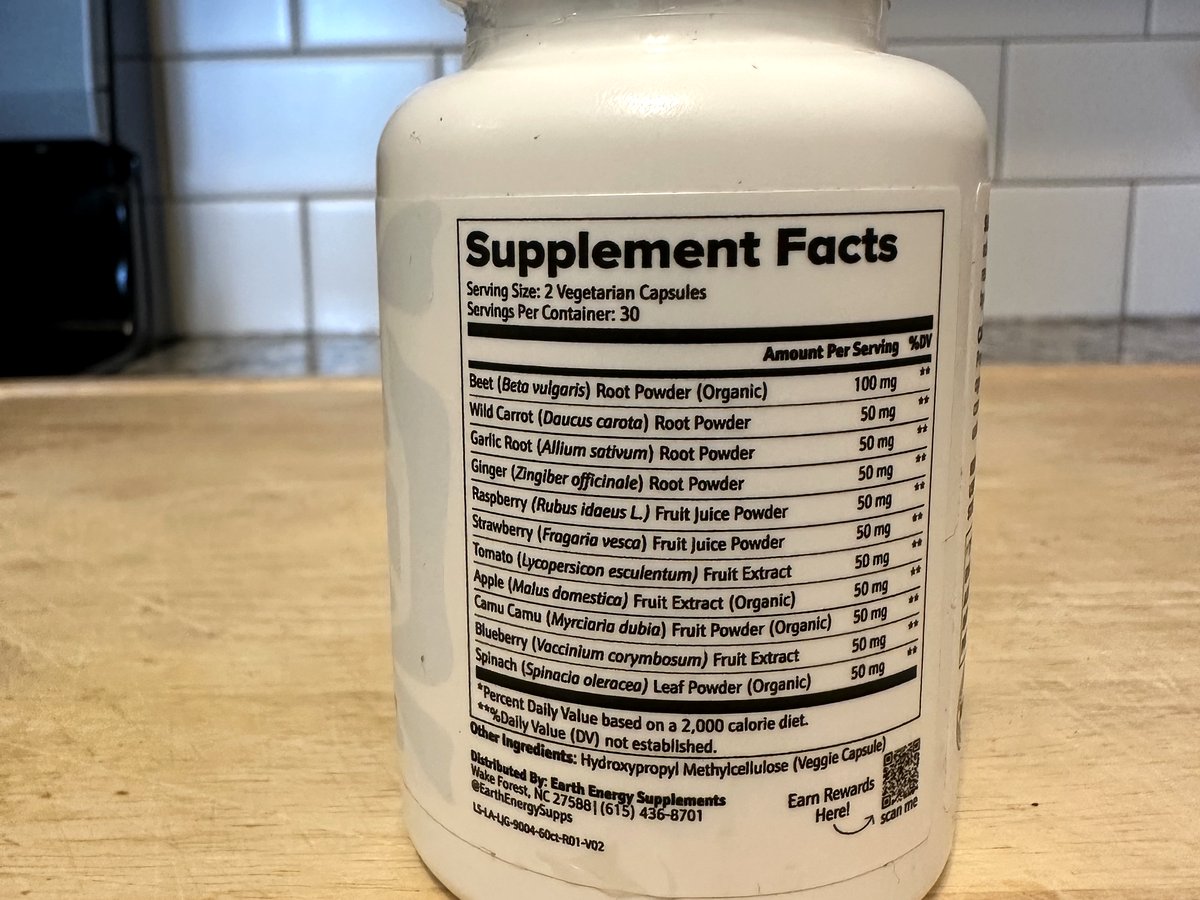 Earth Energy Fruits and Veggies Supplement Facts label listing all 11 ingredient amounts: organic beet root 100 mg and 50 mg each of wild carrot, garlic, ginger, raspberry, strawberry, tomato, organic apple, organic camu camu, blueberry and organic spinach