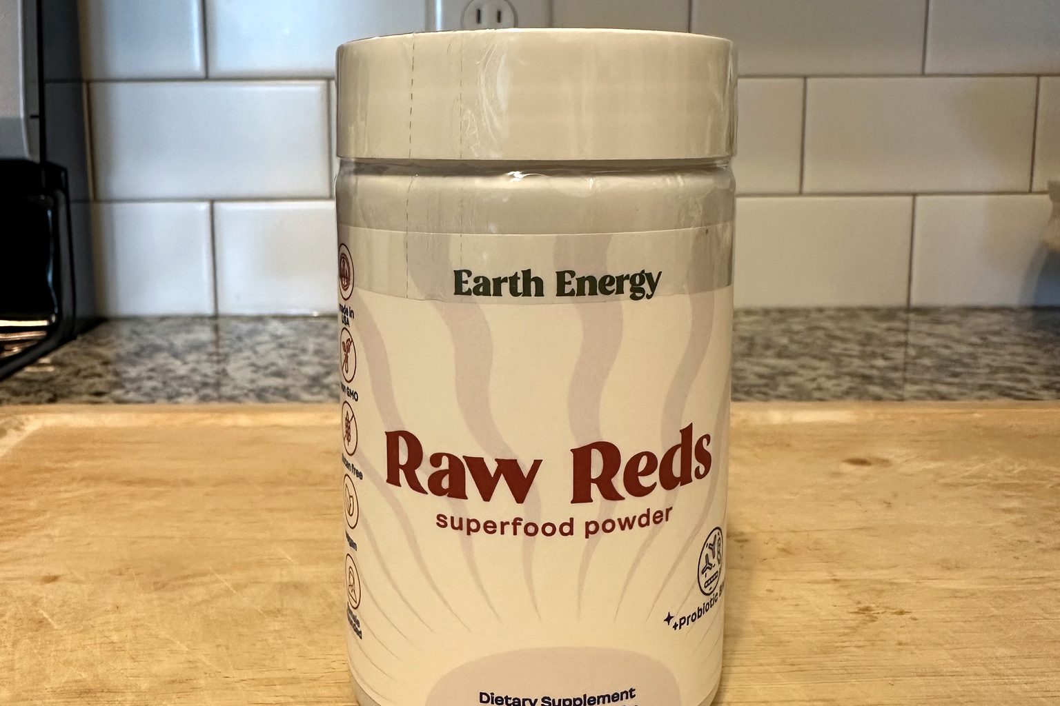 Earth Energy Raw Reds superfood powder jar on our kitchen counter, 30 servings
