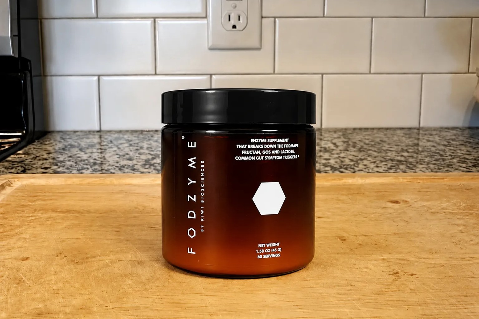 A FODZYME jar by Kiwi Biosciences on our kitchen counter, 60-serving Home supply