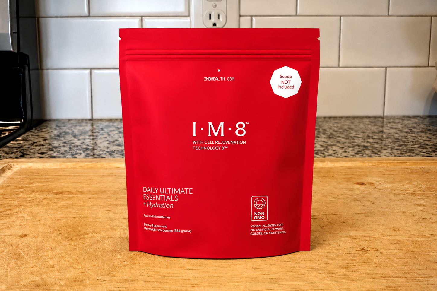 IM8 Daily Ultimate Essentials pouch (Mixed Berries) on our kitchen counter, from im8health.com