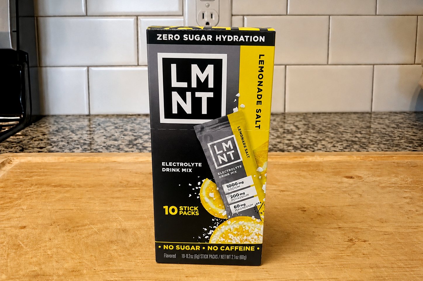 LMNT Lemonade Salt 10-stick box on our kitchen counter, front panel stating 1,000 mg sodium, zero sugar, no caffeine