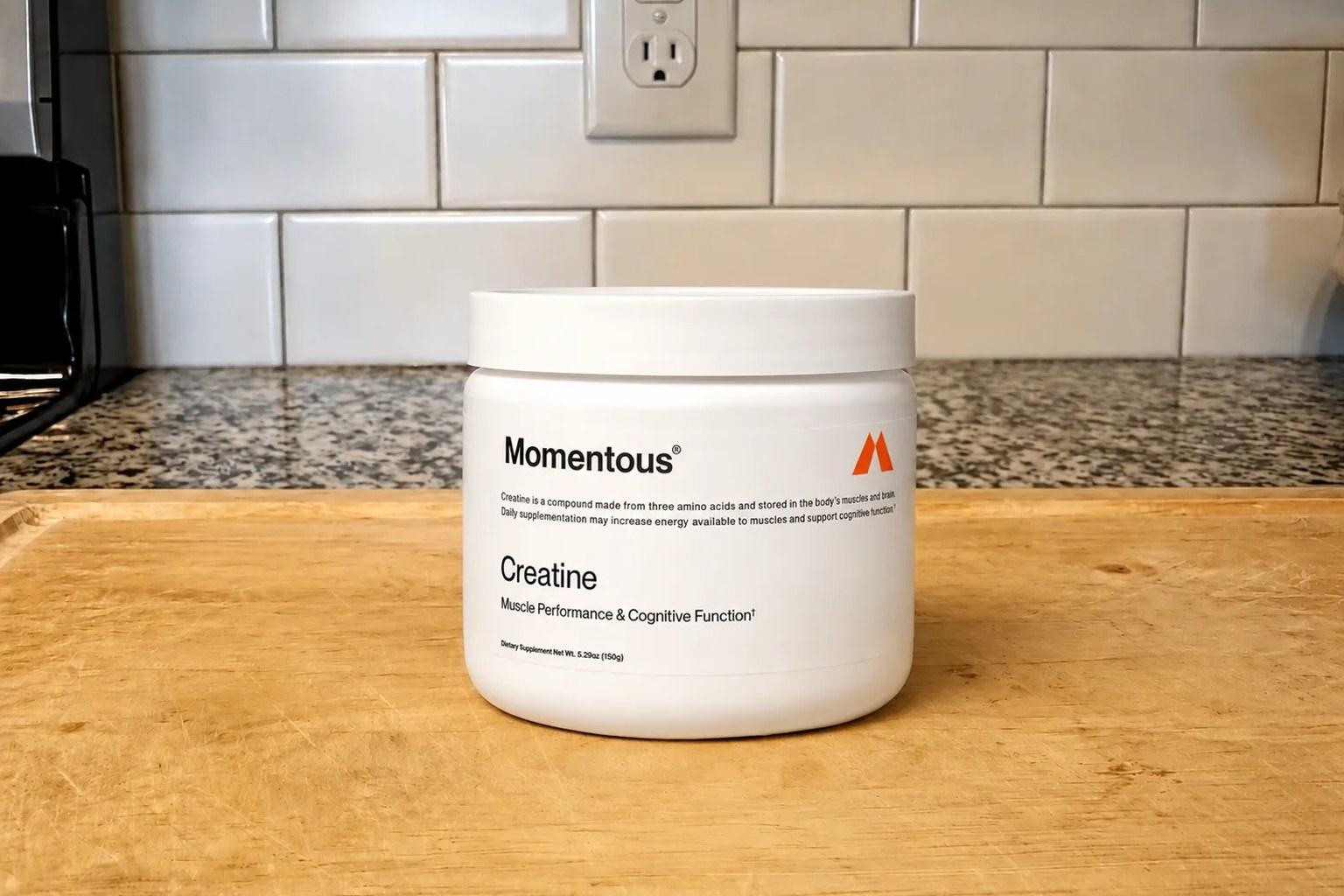 A tub of Momentous Creatine monohydrate on our kitchen counter, 90-serving size