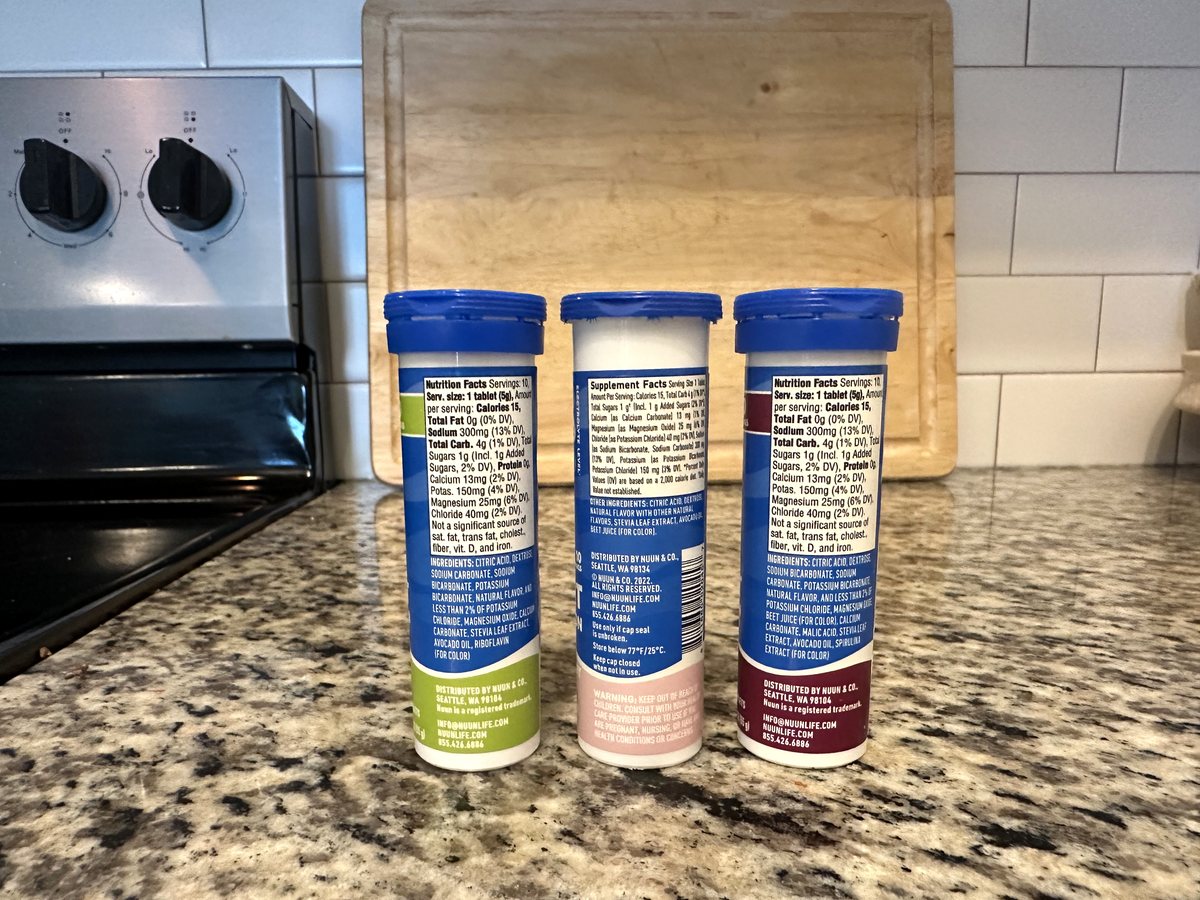 Three Nuun Sport tubes showing their Nutrition and Supplement Facts panels: 1 tablet 5 g, 10 servings, 15 calories, sodium 300 mg, potassium 150 mg, magnesium 25 mg, calcium 13 mg, chloride 40 mg, 1 g sugar