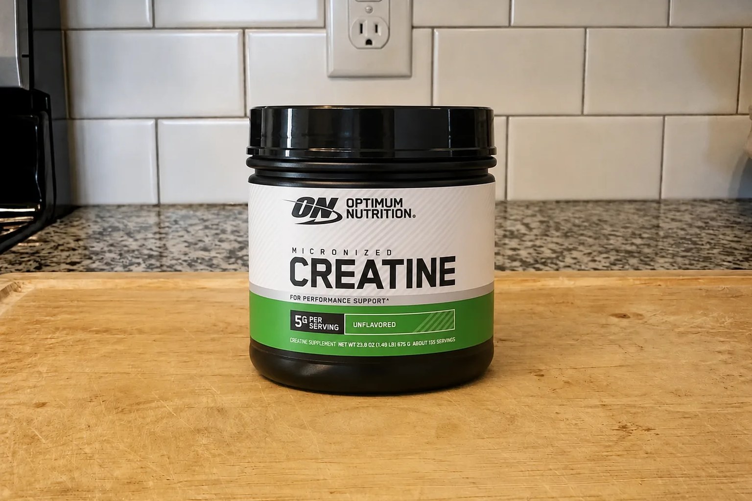 A tub of Optimum Nutrition Micronized Creatine Monohydrate powder on our kitchen counter, 600 g