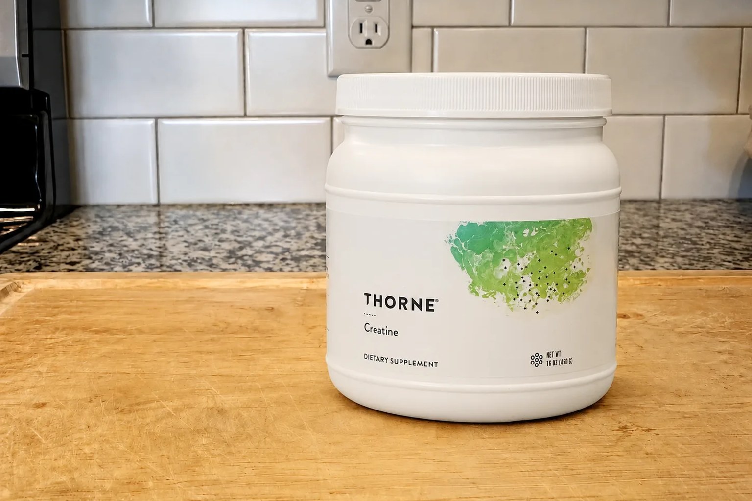A tub of Thorne Creatine on our kitchen counter, 90-serving size, 450 g