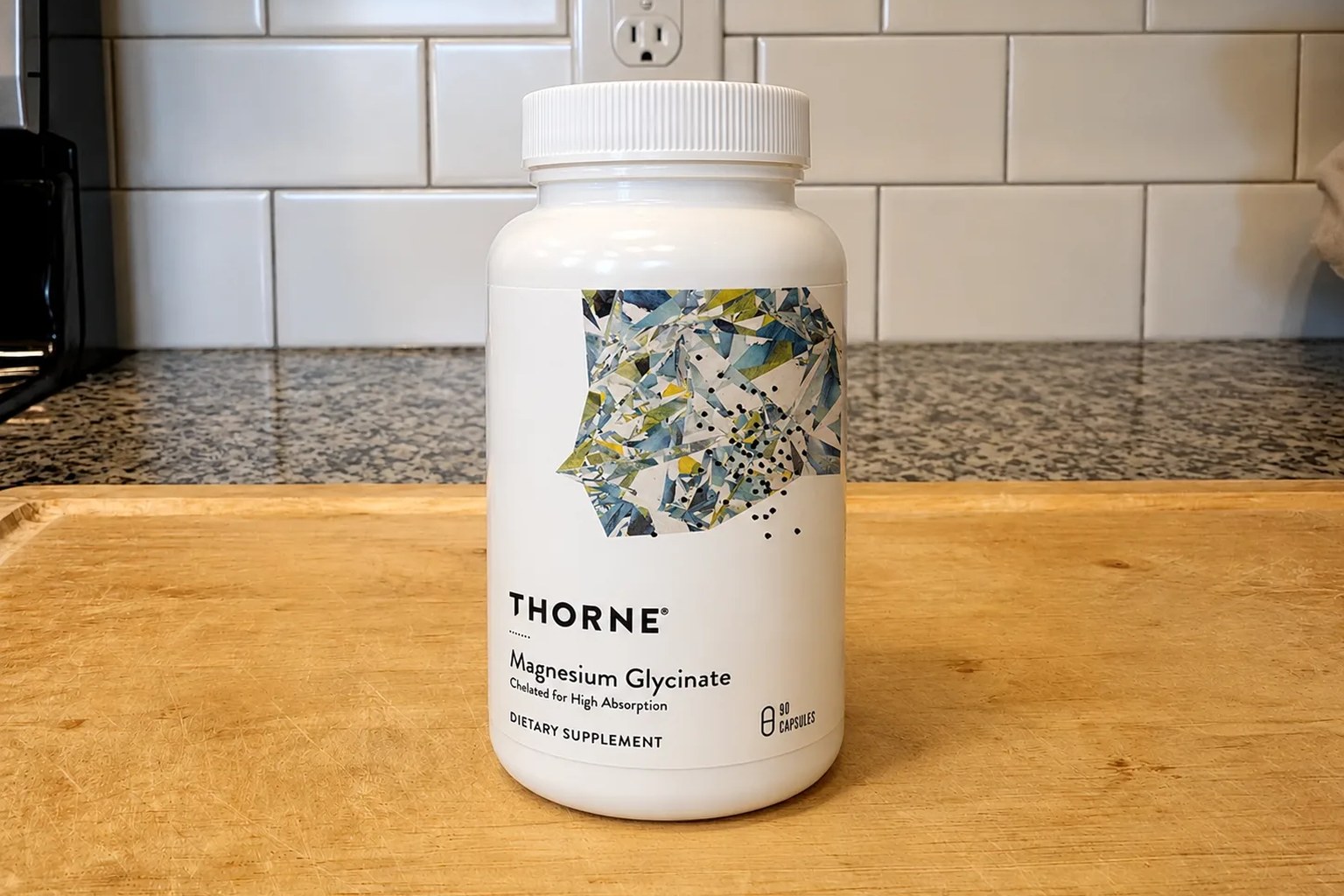 A Thorne Magnesium Bisglycinate tub on our kitchen counter, 6.5&nbsp;oz flavored powder, ~60 servings